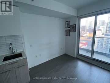 Toronto (Church-Yonge Corridor) condo for rent - A kitchen with a sink and a window overlooking a cityscape.