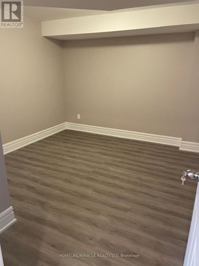 Vaughan (Kleinburg) apartment for rent - A room with wooden flooring and white baseboards.
