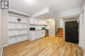 Toronto (Pleasant View) apartment for rent - A kitchen with white cabinets and a wooden floor.