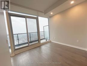 Toronto (Church-Yonge Corridor) condo for rent - A room with a large window and a balcony overlooking a cityscape.