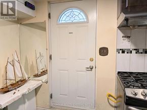 Toronto (Mount Olive-Silverstone-Jamestown) apartment for rent - A white door with a glass window is in the middle of a kitchen.