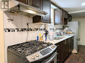 Toronto (Mount Olive-Silverstone-Jamestown) apartment for rent - A kitchen with a stove top oven and a refrigerator.