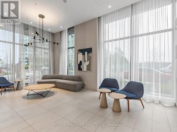 Toronto (Islington-City Centre West) condo for rent - A living room with a grey sofa, a blue chair and a wooden table.