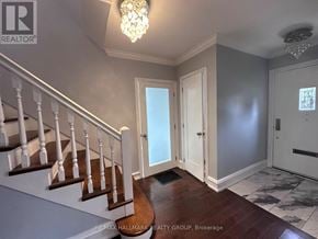 Ottawa apartment for rent - A hallway with a staircase and a chandelier.