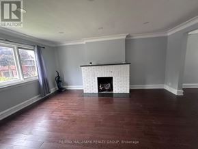 Ottawa apartment for rent - A room with a fireplace and wood flooring.