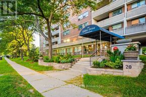 Toronto (Eglinton East) condo for rent - A building with a blue awning and the number 20 on a stone pillar.