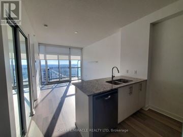 Mississauga (City Centre) condo for rent - A kitchen with a sink and a window overlooking the beach.