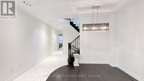 Markham (Village Green-South Unionville) apartment for rent - A spacious room with a staircase and a chandelier.