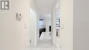 Markham (Village Green-South Unionville) apartment for rent - A hallway with a white floor and walls, leading to a bedroom.