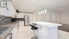 Markham (Village Green-South Unionville) apartment for rent - A kitchen with white cabinets and a marble countertop.