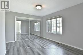 Oakville (Fd Ford) apartment for rent - A spacious room with a sliding glass door and a wooden floor.