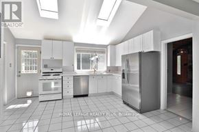 Oakville (Fd Ford) apartment for rent - A kitchen with white cabinets and appliances is on the market with Royal LePage Realty Plus.