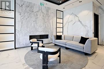 Toronto (Dovercourt-Wallace Emerson-Junction) condo for rent - A living room with a grey couch and a marble wall.