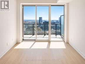 Toronto (Regent Park) condo for rent - A room with a view of the city through large windows.