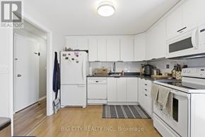 Oshawa (Donevan) apartment for rent - A white kitchen with a refrigerator, microwave, and oven.
