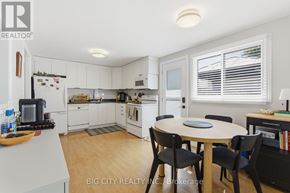 Oshawa (Donevan) apartment for rent - A kitchen with a table and chairs in the middle of it.