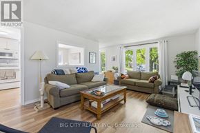 Oshawa (Donevan) apartment for rent - A living room with a couch, a coffee table, and a lamp.