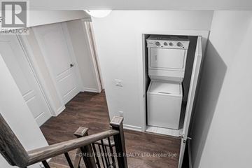 Markham (Cornell) townhouse for rent - A small kitchen with a white oven and a wooden floor.