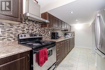 Brampton (Credit Valley) apartment for rent - A kitchen with a stove top oven and a microwave.