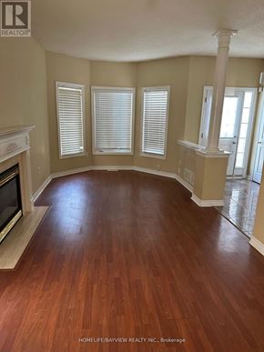 Barrie (Painswick South) apartment for rent - A living room with wood flooring and a fireplace.
