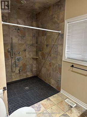 Barrie (Painswick South) apartment for rent - A bathroom with a tiled floor and a walk-in shower.