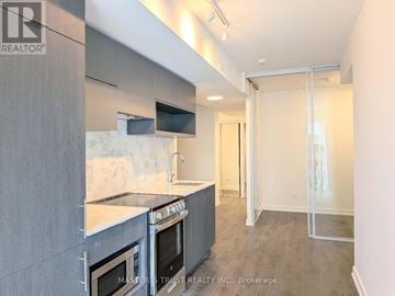 Toronto (Church-Yonge Corridor) condo for rent - A kitchen with a stove top oven and a microwave.