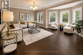 Newmarket (Stonehaven-Wyndham) apartment for rent - A well-lit, spacious living room with a white sofa set and a chandelier.