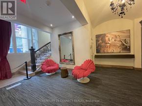 Toronto (Church-Yonge Corridor) condo for rent - A room with a grey carpet and a red chair.