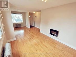 Toronto (Woodbine-Lumsden) apartment for rent - A living room with a fireplace and wood flooring.