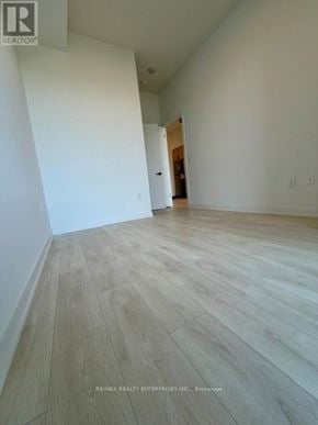 Burlington (Alton) condo for rent - A room with wooden flooring and white walls.