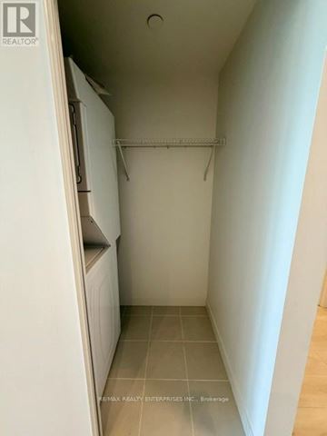 Burlington (Alton) condo for rent - A small, empty kitchen with a white refrigerator and a white cabinet.