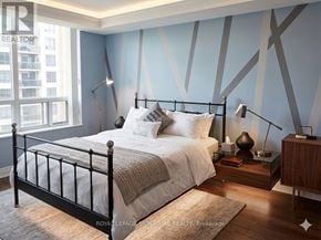 Toronto (Willowdale East) condo for rent - A bedroom with a bed, nightstand, and lamp.