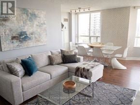 Toronto (Willowdale East) condo for rent - A living room with a couch, chairs, and a painting on the wall.