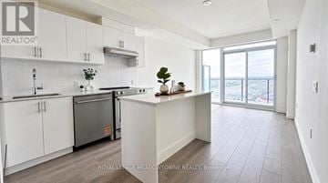Vaughan (Vellore Village) condo for rent - A modern kitchen with white cabinets and a large island.