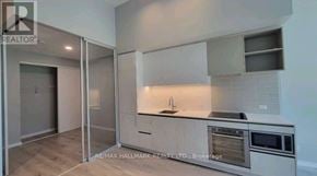 Vaughan (Vaughan Corporate Centre) condo for rent - A modern kitchen with a sink, oven, and cabinets.