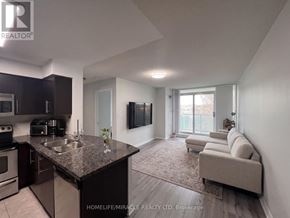 Mississauga (Central Erin Mills) condo for rent - A modern kitchen with dark brown cabinets and a granite countertop.