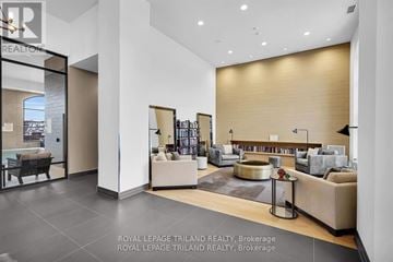 London North (North R) condo for rent - A modern living room with a large sofa and a bookshelf.