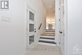 Ottawa apartment for rent - A white door with a glass window is in a hallway.