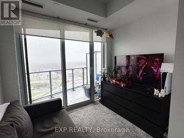 Toronto (Islington-City Centre West) condo for rent - A living room with a large couch and a flat screen TV.