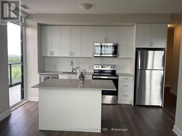Oakville (Jm Joshua Meadows) condo for rent - A modern kitchen with white cabinets and stainless steel appliances.