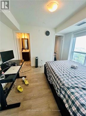 Toronto (Islington-City Centre West) condo for rent - A bedroom with a bed, desk, and window.