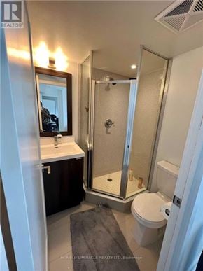 Toronto (Islington-City Centre West) condo for rent - A bathroom with a toilet, sink, and shower.