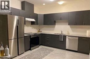 Zorra (Thamesford) townhouse for rent - A modern kitchen with a refrigerator, oven, and sink.