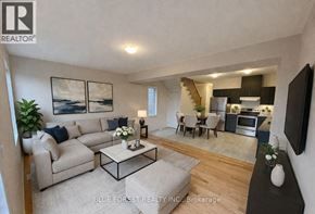 Zorra (Thamesford) townhouse for rent - A living room with a couch, a coffee table, and a television.