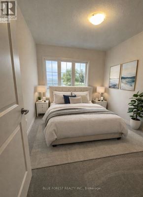 Zorra (Thamesford) townhouse for rent - A bedroom with a large bed and two lamps.