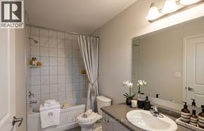 Zorra (Thamesford) townhouse for rent - A bathroom with a white tub, sink, and toilet.