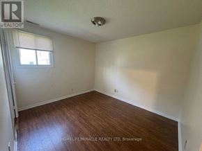 Toronto (Kennedy Park) townhouse for rent - A room with wooden flooring and a window with blinds.