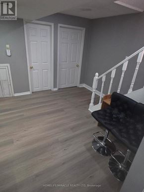 Brampton (Fletcher's Creek South) apartment for rent - A bathroom with a black tiled wall and a wooden table.