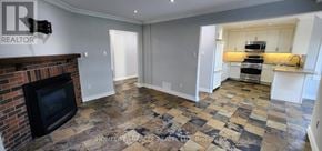 Ajax (Central) apartment for rent - A living room with a brick fireplace and a checkered floor.