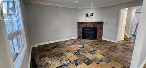 Ajax (Central) apartment for rent - A living room with a fireplace and a stone floor.